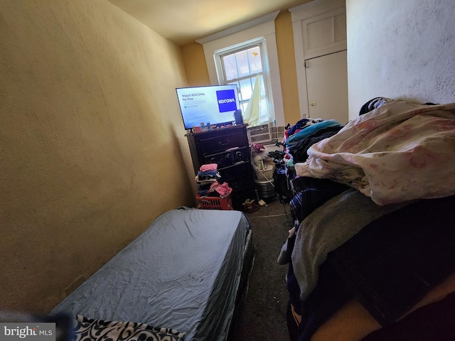 bedroom with carpet floors and a textured wall