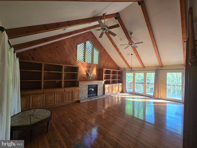 3450 Middle Ridge Rd, Newport, PA 17074 - unfurnished living room featuring wood walls, dark wood-type flooring, a glass covered fireplace, beam ceiling, and high vaulted ceiling