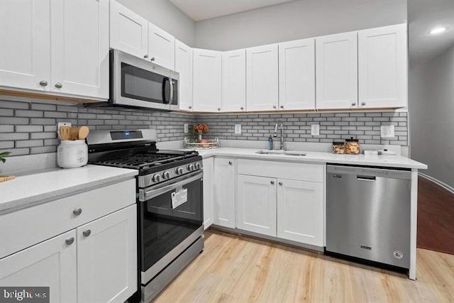 1224 James St, Baltimore, MD 21223 - kitchen featuring stainless steel appliances, a sink, light countertops, and white cabinetry