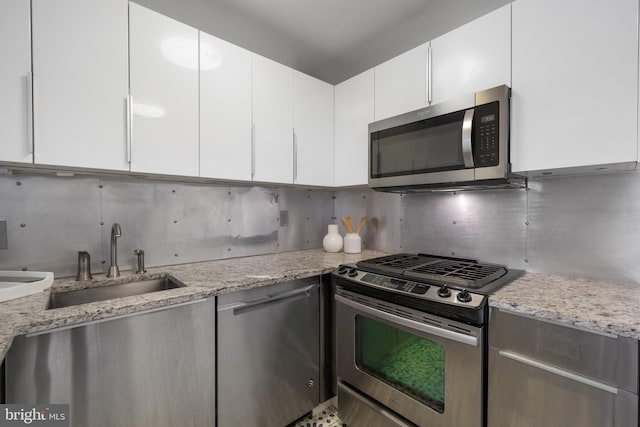 1250 4th St SW Unit W203, Washington, DC 20024 - kitchen with stainless steel appliances, a sink, tasteful backsplash, and white cabinets