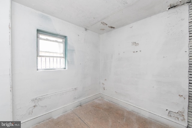 spare room with unfinished concrete floors