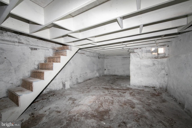 unfinished basement featuring stairway