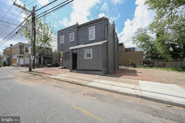 view of front of house featuring fence, a chimney, and a residential view