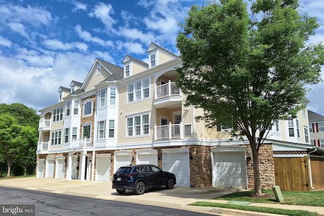 1509 Feral Dae Ln Unit 204, Annapolis, MD 21409 - view of property featuring an attached garage, stone siding, and driveway