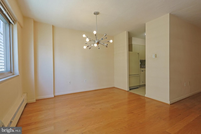 1900 John F Kennedy Blvd Unit 2003, Philadelphia, PA 19103 - empty room with baseboard heating, a chandelier, healthy amount of natural light, and light wood-style floors