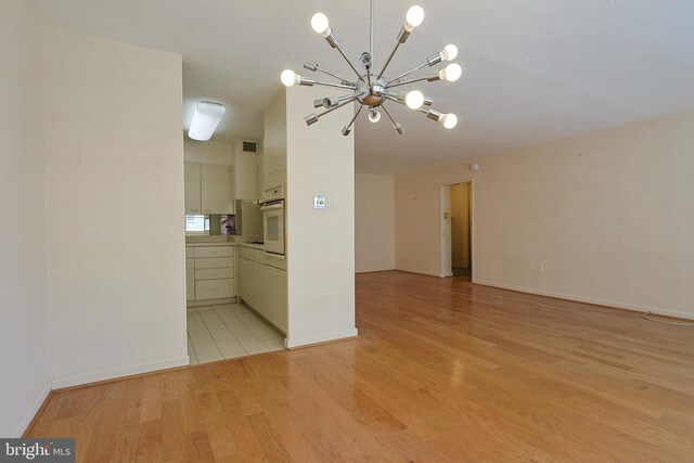 1900 John F Kennedy Blvd Unit 2003, Philadelphia, PA 19103 - unfurnished room featuring a chandelier, light wood-style flooring, and baseboards