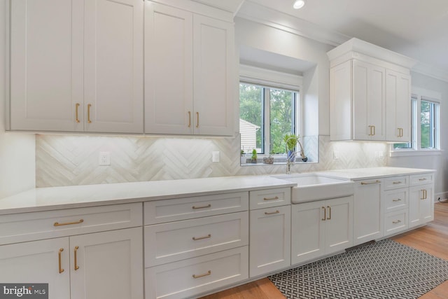 302 Jade Ct NW, Vienna, VA 22180 - kitchen with a sink, plenty of natural light, light countertops, crown molding, and recessed lighting