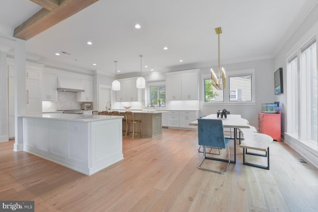 302 Jade Ct NW, Vienna, VA 22180 - kitchen with a spacious island, custom range hood, tasteful backsplash, white cabinets, and crown molding