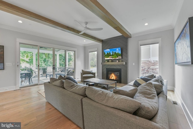 302 Jade Ct NW, Vienna, VA 22180 - living room with beam ceiling, a large fireplace, light wood-style floors, a ceiling fan, and baseboards