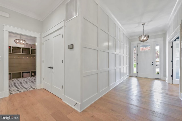 302 Jade Ct NW, Vienna, VA 22180 - entryway featuring a chandelier, light wood finished floors, and crown molding