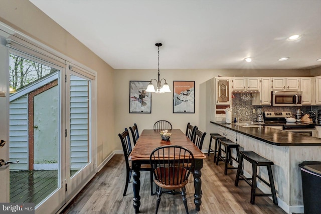 dining room featuring a chandelier, dark wood-style floors, recessed lighting, and baseboards