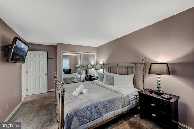 carpeted bedroom with baseboards and a closet