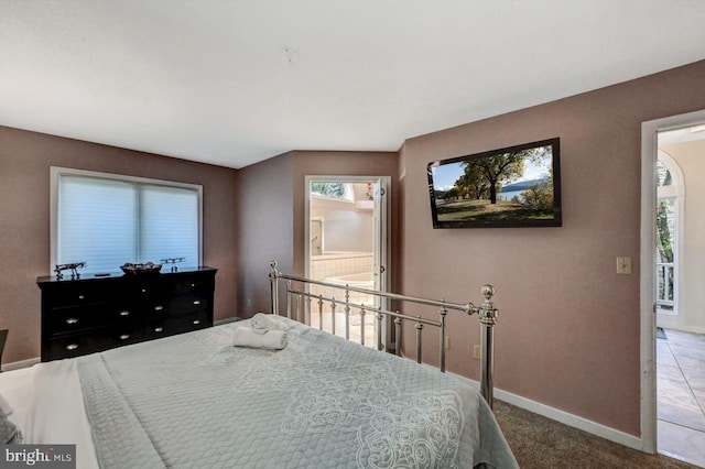 carpeted bedroom with baseboards and connected bathroom