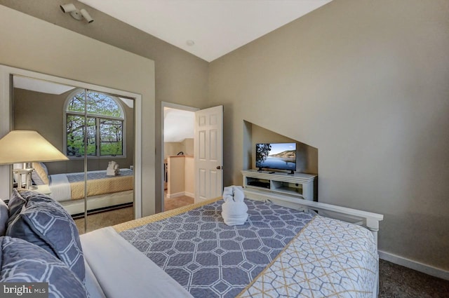 carpeted bedroom with baseboards and a closet
