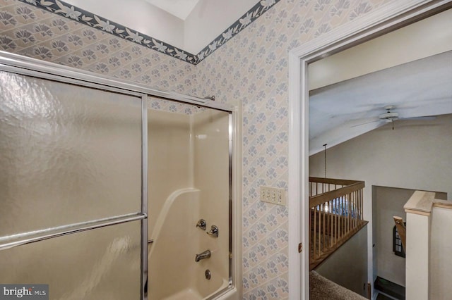 bathroom with wallpapered walls, a ceiling fan, and shower / bath combination with glass door