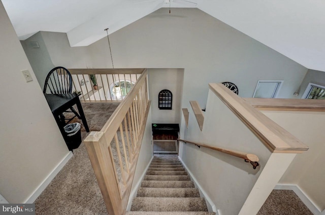 staircase featuring carpet, baseboards, high vaulted ceiling, and a ceiling fan
