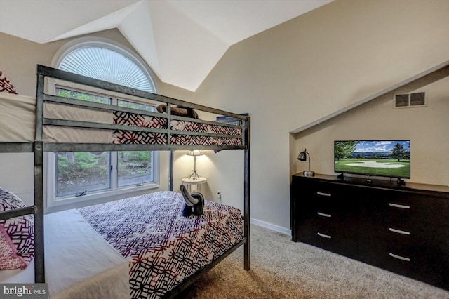 carpeted bedroom featuring vaulted ceiling and baseboards