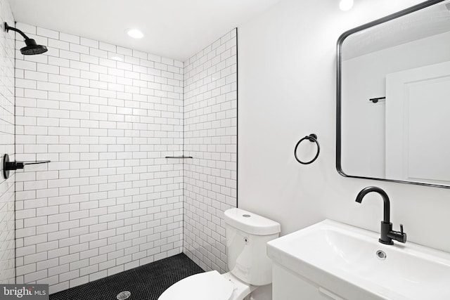 bathroom with toilet, a shower stall, vanity, and recessed lighting