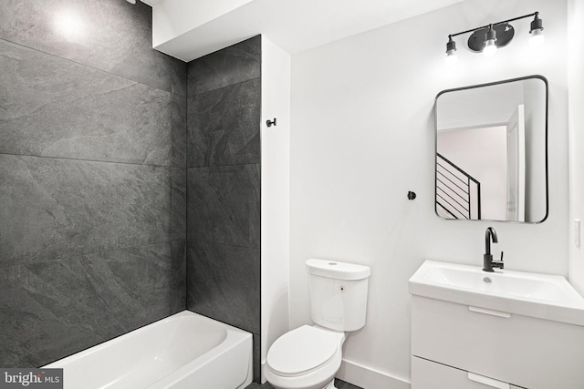 full bath featuring toilet, vanity, and baseboards