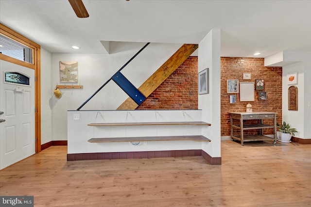 entrance foyer featuring baseboards, light wood finished floors, brick wall, recessed lighting, and ceiling fan
