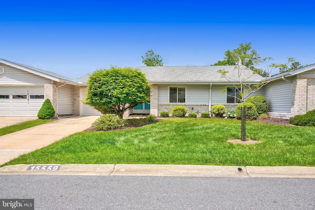 single story home with brick siding, a front lawn, and driveway