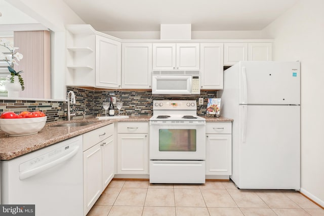 kitchen with white appliances, a sink, open shelves, tasteful backsplash, and white cabinetry