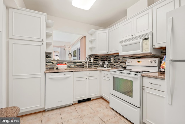 kitchen featuring white appliances, open shelves, a sink, decorative backsplash, and light tile patterned floors