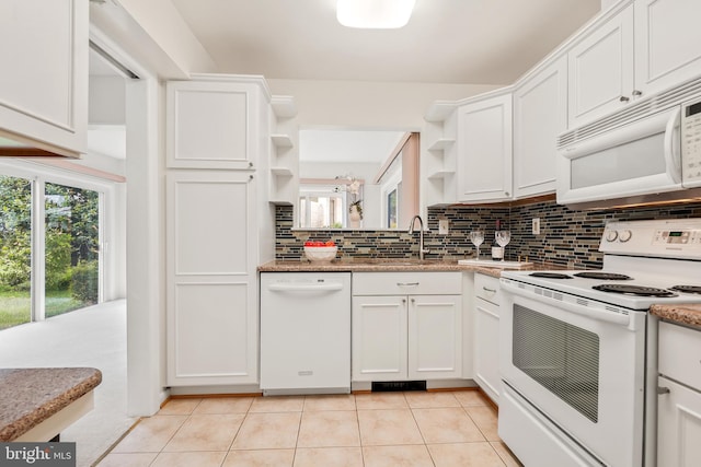 kitchen featuring white appliances, open shelves, tasteful backsplash, light tile patterned floors, and white cabinetry