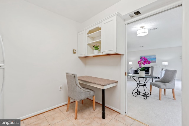 dining room featuring baseboards and light tile patterned flooring