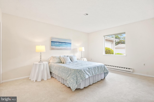 bedroom featuring baseboard heating, light colored carpet, and baseboards