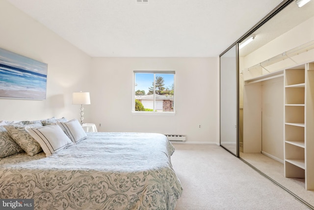 carpeted bedroom with a baseboard radiator, baseboards, and a closet
