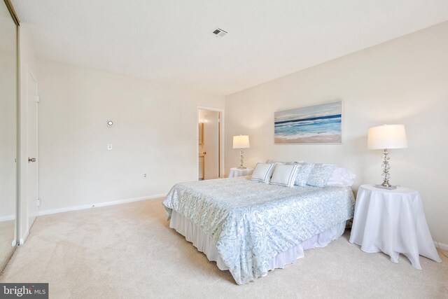 bedroom featuring light colored carpet and baseboards