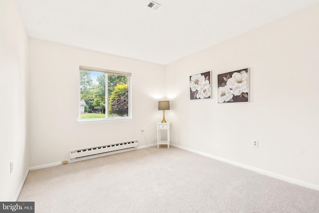 carpeted empty room featuring a baseboard heating unit and baseboards