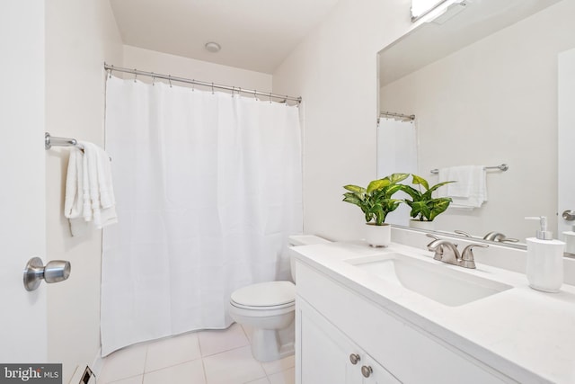 full bathroom featuring toilet, tile patterned flooring, vanity, and baseboard heating