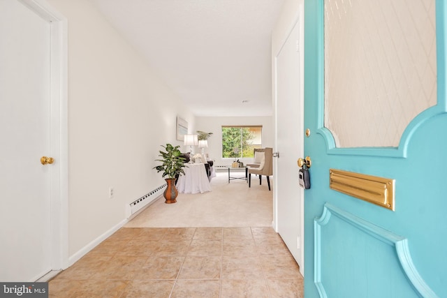 carpeted foyer entrance featuring a baseboard heating unit
