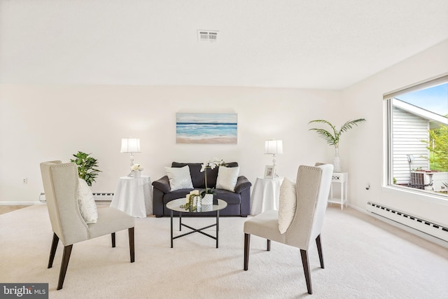 living room featuring light colored carpet, a baseboard radiator, and baseboards