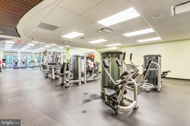 gym with a paneled ceiling