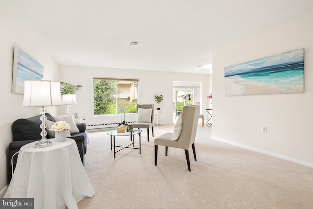 living room featuring carpet flooring, baseboards, and a baseboard heating unit