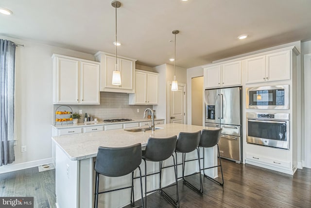 718 Quarry Point Rd, Malvern, PA 19355 - kitchen with appliances with stainless steel finishes, a sink, dark wood-type flooring, white cabinets, and decorative backsplash