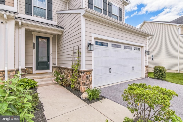 718 Quarry Point Rd, Malvern, PA 19355 - entrance to property featuring an attached garage, stone siding, and driveway