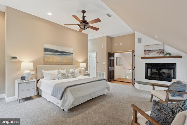 bedroom with carpet floors, baseboards, a fireplace with raised hearth, recessed lighting, and a ceiling fan