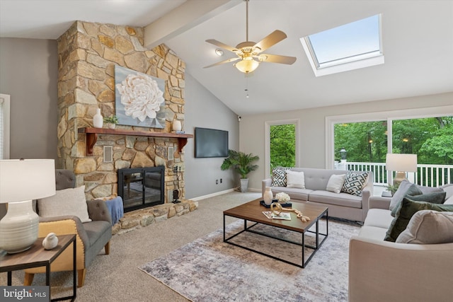 carpeted living area with beamed ceiling, a ceiling fan, a skylight, baseboards, and high vaulted ceiling