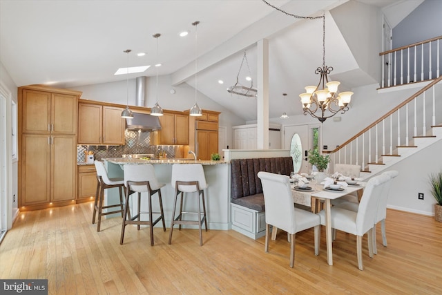 dining room featuring light wood-type flooring, high vaulted ceiling, stairs, beamed ceiling, and a chandelier