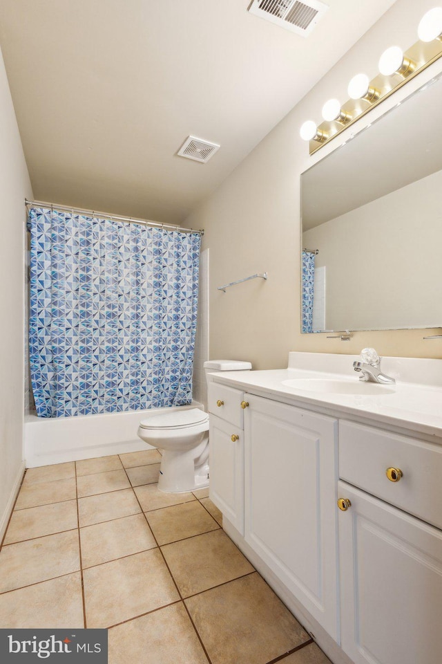 full bath with toilet, tile patterned flooring, vanity, and shower / tub combo