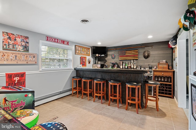 indoor dry bar featuring a baseboard heating unit, recessed lighting, and tile patterned flooring