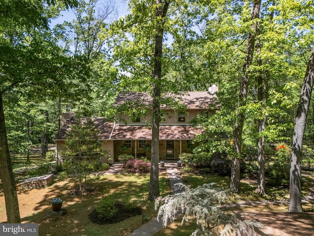 view of front of property with a chimney and stucco siding