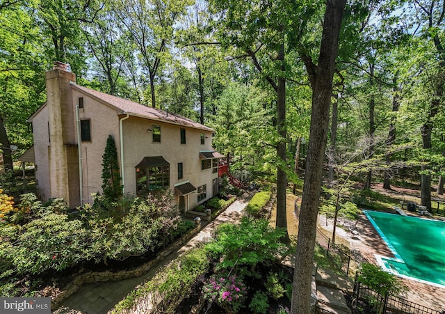 view of home's exterior featuring stucco siding and a chimney
