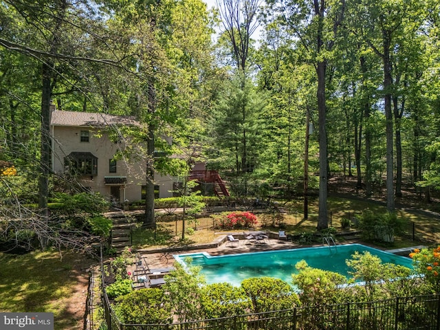 view of swimming pool featuring a diving board