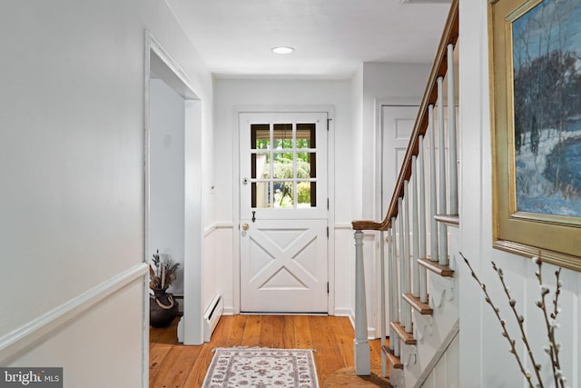 entryway featuring light wood-type flooring, stairs, recessed lighting, and a baseboard radiator