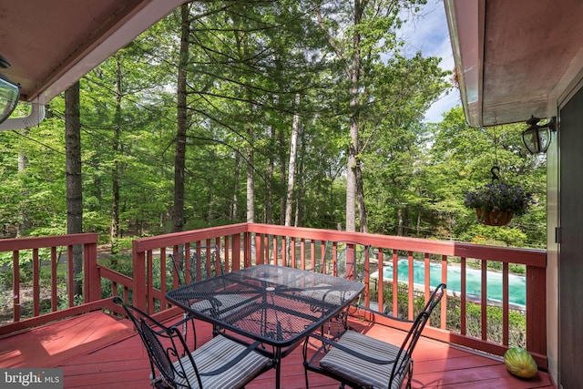 deck featuring outdoor dining area and an outdoor pool